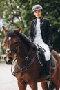 Rider in action on a dressage horse. Lovely girl jockey sitting in the saddle on a horse shooting close-up Royalty Free Stock Photo