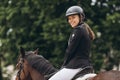 Rider in action on a dressage horse. Lovely girl jockey sitting in the saddle on Royalty Free Stock Photo