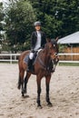 Rider in action on a dressage horse. Lovely girl jockey sitting in the saddle on a horse shooting close-up