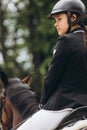 Rider in action on a dressage horse. Lovely girl jockey sitting in the saddle on a horse shooting close-up Royalty Free Stock Photo