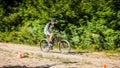 Rider in action at freestyle mountain bike downhill style. Bicyclist riding a bicycle in a non-urban area