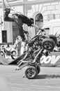 The rider on the ATV shows risky stunts.