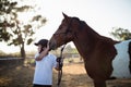 Rider boy caressing a horse in the ranch Royalty Free Stock Photo