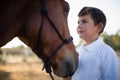 Rider boy caressing a horse in the ranch Royalty Free Stock Photo
