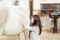 Rider Caressing Horse In Stable Royalty Free Stock Photo