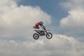 Rider carries out a trick with the motorcycle on background of the blue cloud sky. German-Stuntdays, Zerbst - 2017, Juli 08 Royalty Free Stock Photo