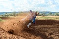 Rider on a cross-country motorcycle in sports equipment turns on a sharp turn at high speed