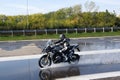 Rider doing aquaplaning tests on a motorbike Royalty Free Stock Photo