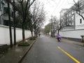 Rider driving along the street with purple coat in the rain