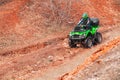 Rider driving in the quadbike race in winter in the forest