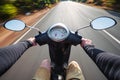 Rider driving scooter on an asphalt road. Motion blurred backgro Royalty Free Stock Photo