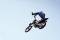 Rider in a helmet performs a risky stunt in the air on a motorcycle Royalty Free Stock Photo