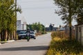 Rider on his enduro motorbike on a village road near Targoviste, Romania, 2021