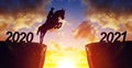 The rider on the horse jump from 2020 to New Year 2021 at sunset. Royalty Free Stock Photo