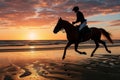 rider on horseback racing along the beach at sunrise Royalty Free Stock Photo