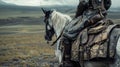 A rider on horseback traverses a desolate landscape his leather saddle adorned with silver and gold sigils. At his side