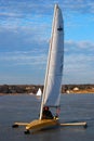 An ice yacht pulls into a frozen harbor