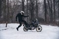 Rider man jump near adventure motorcycle. Winter fun. snowy day. the snow fall. off road dual sport crazy extreme ride, active