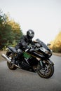 Rider on a motorbike driving at sunset - space for your text biker and motorbike ready to ride