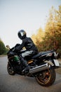 Rider on a motorbike driving at sunset - space for your text biker and motorbike ready to ride