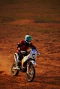 Rider on a off-road motorbike on the desert rally. Rally raid THE GOLD OF KAGAN-2021. 24.04.2021 Astrakhan, Russia