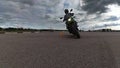 The rider slowly rides on camera on motorbike