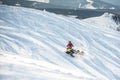 Rider on the snowmobile in the mountains . the movement of the traverse