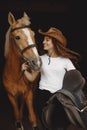Portrait of woman in brown leather hat with a horse Royalty Free Stock Photo