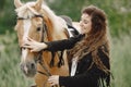 Portrait of rider woman with a brown horse Royalty Free Stock Photo