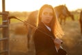 Rider woman with whip at the sunset Royalty Free Stock Photo