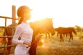 Rider woman with whip at the sunset Royalty Free Stock Photo