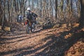 Riders on cross enduro motorcycles riding through forest