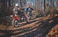 Riders on cross enduro motorcycles riding through forest