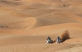 Riders on dirt bikes in a desert