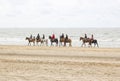 Riders on horses on the beach close to North sea