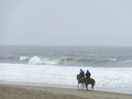 Riders horses trotting at coastline of Chorrillos, Lima.