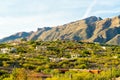 Ridge rilled with houses or homes in a mansion community in the hills of the sonora desert in arizona with visible moutains Royalty Free Stock Photo