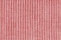 Ridge texture background of velour corduroy red cloth. Large ribbed, coarse weaving fabric Royalty Free Stock Photo