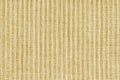 Ridge texture background of velour corduroy yellow cloth. Large ribbed, coarse weaving fabric Royalty Free Stock Photo