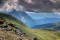 Ridges and meadows in blue mist and gray clouds Carnia Italy