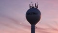 Ridgeway wi water tower at dusk with colored sky and cell tower antennas