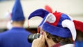 Ridiculously dressed and excited fan taking photos on camera, waiting for match