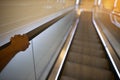 Riding down on escalator holding safety handrail Royalty Free Stock Photo