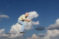 A Man Rides on a Cloud in the Shape of a Dog Royalty Free Stock Photo