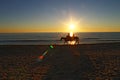Riding horses on the beach during sunset