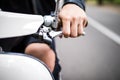 Riding motorcycle, close up of hand on handlebar of scooter