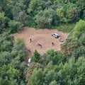 Riding motorcycles in the forest, top view. Cross country motocross among trees - Moscow, Russia, august 29, 2021