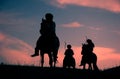Riding nomadic horsemen on sunset