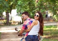 Riding a scooter together. Young couple riding a scooter Royalty Free Stock Photo