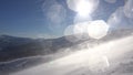 Riding at Ski Resort while Huge Blizzard at Sunny Day